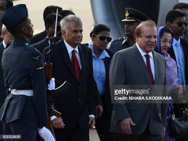 Pakistani Prime Minister Nawaz Sharif and his wife Kalsoom Nawaz Sharif walk with Sri Lankan Prime Minister Ranil Wickremesinghe at Bandaranaike...