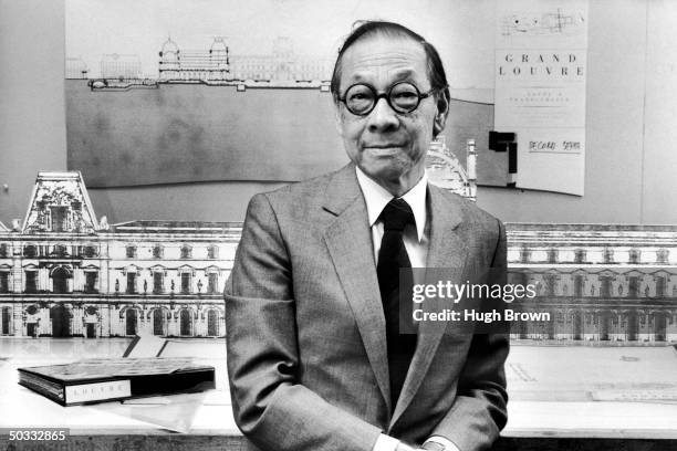 Architect I.M. Pei in his office, standing in front of drawing of The Louvre Museum.
