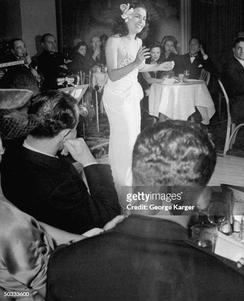 Singer Lena Horne singing Cole Porter's Let's Do It w/o a microphone in front of rapt guests in Savoy-Plaza Hotel's Cafe Lounge.