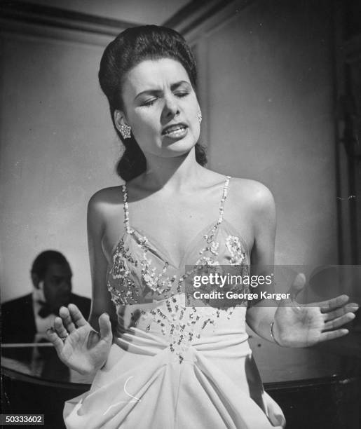 Singer Lena Horne singing Cole Porter's Let's Do It w/o a microphone in front of rapt guests in Savoy-Plaza Hotel's Cafe Lounge.