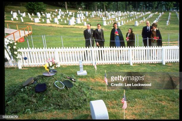 Unident. White House employees paying respects at grave site to slain President John F. Kennedy on first birthday after the assassination.