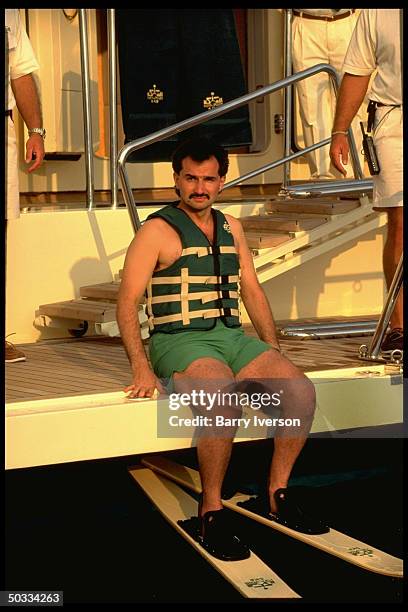 Billionaire investor Saudi Prince Alwaleed sporting life vest & water skiis, on his yacht, Kingdom 5-KR, formerly owned by US real estate mogul...