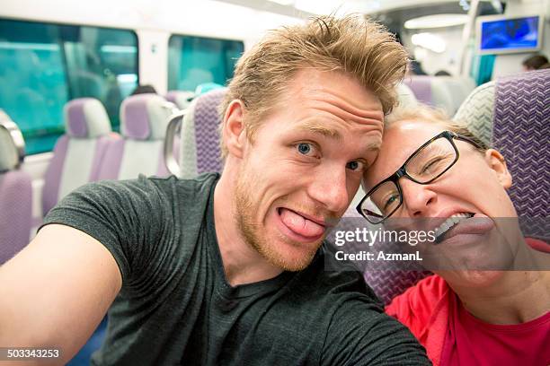 selfie of a young couple on a train - romantische activiteit stockfoto's en -beelden