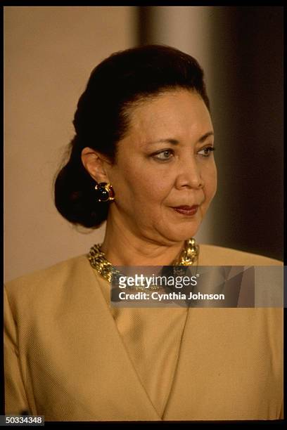 Alma Powell listening as her husband, retired Gen. Colin Powell, announces his decision not to run for pres. In 1996.