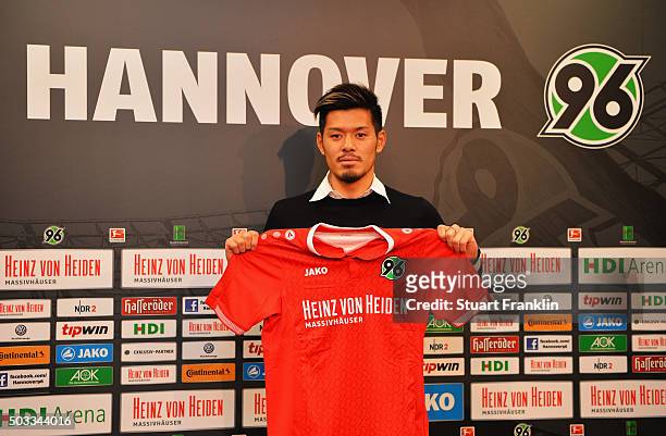 Hotaru Yamaguchi of Hannover holds his new team shirt during a press conference to announce his joining of Hannover 96 on January 4, 2016 in Hanover,...