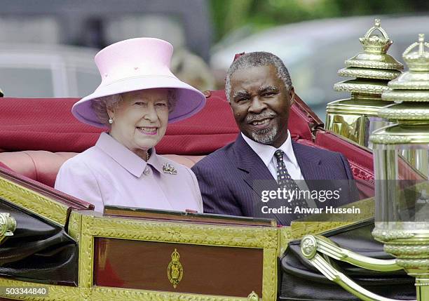 Queen Elizabeth ll and South African President Thabo Mbeki travel in an open carriage at the start of his State Visit to Britain on June 12, 2001 in...