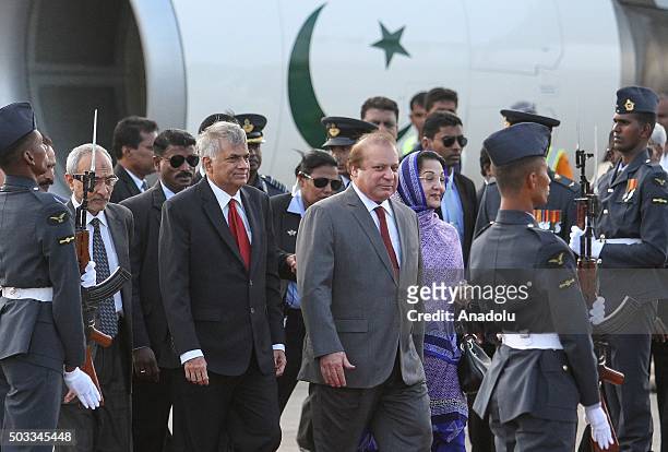 Pakistani Prime Minister Nawaz Sharif and his wife Kalsoom Nawaz Sharif walk near Sri Lankan Prime Minister Ranil Wickremesinghe at Bandaranaike...