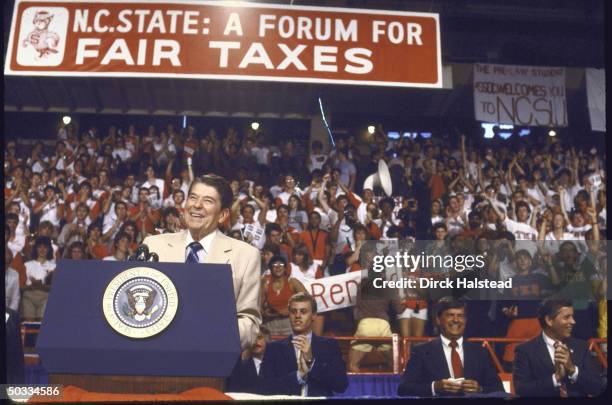 President Ronald W. Reagan poised at microphone addressing fair tax forum at North Carolina State University.