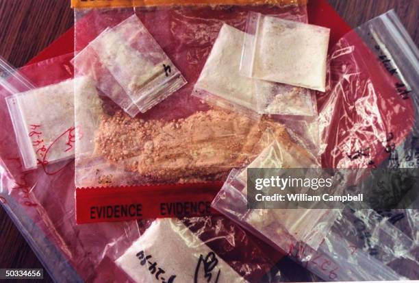 Plastic bags of crank in police custody after drug bust.