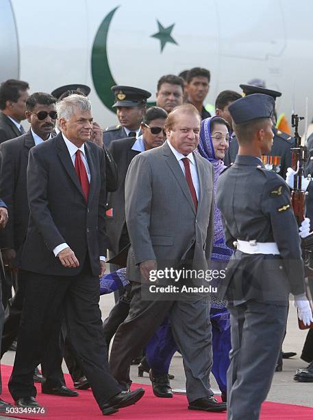 Pakistani Prime Minister Nawaz Sharif and his wife Kalsoom Nawaz Sharif walk near Sri Lankan Prime Minister Ranil Wickremesinghe at Bandaranaike...