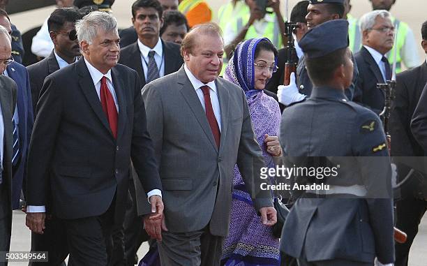 Pakistani Prime Minister Nawaz Sharif and his wife Kalsoom Nawaz Sharif walk near Sri Lankan Prime Minister Ranil Wickremesinghe at Bandaranaike...