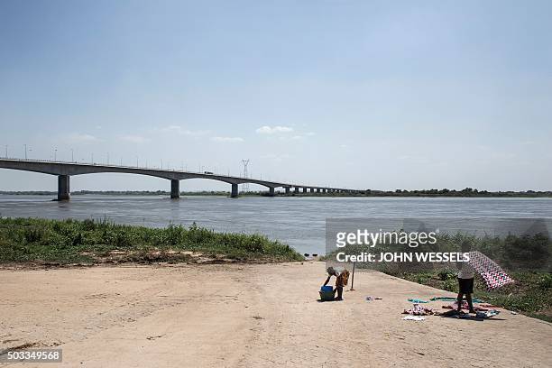 Women dry and fold their clothes on the edge of the Zambezi River in Mozambique on December 9, 2015. Heavy rainfall in early 2015 caused major...