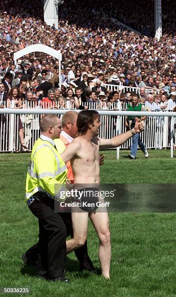 Streaker being led off field at the Epsom Derby at which the Royal family was in attendance.