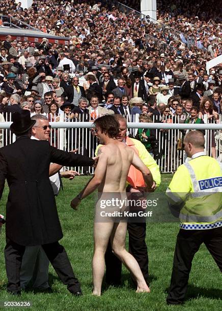 Streaker being led off field at the Epsom Derby at which the Royal family was in attendance.