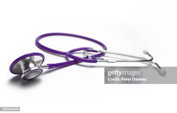 close-up of purple stethoscope with copy space - stethoskop stock-fotos und bilder