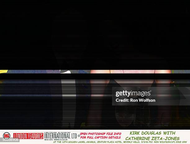 Actor Kirk Douglas sitting w. His daughter-in-law Catherine Zeta-Jones, who presented him w. The Milestone Award at the Golden Laurel Awards at the...