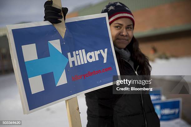 Volunteer Carlee Russell holds a campaign sign for Hillary Clinton, former Secretary of State and 2016 Democratic presidential candidate, before Bill...