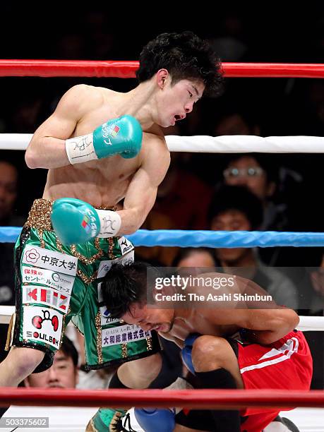 Champion Kosei Tanaka of Japan knocks down Vic Saludar of the Philippines during the WBO Minimumweight Title Bout at Aichi Prefecture Gymnasium on...