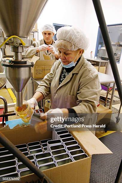 Julia Velez and Frank Cintron fill and pack "Chick Magnet" seasoning into 3 oz. Tins at DennyMike's 'Cue Stuff in Westbrook.