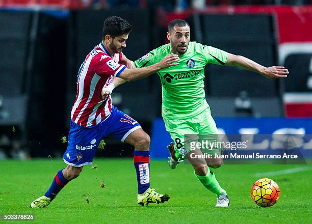 Nacho Cases of Real Sporting de Gijon duels for the ball with Mehdi Lacen of Getafe CF during the La Liga match between Real Sporting de Gijon and...
