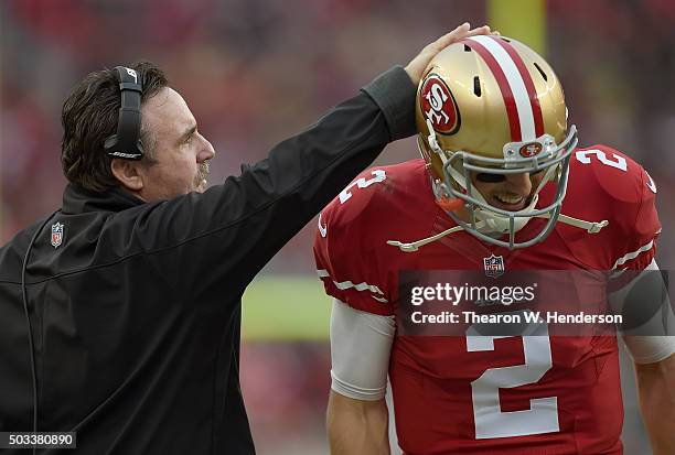 Head coach Jim Tomsula of the San Francisco 49ers talks with his quarterback Blaine Gabbert against the St. Louis Rams during an NFL football game at...