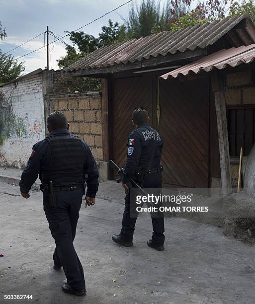 Municipal police officers pass by the house of Gisela Mota, the mayor who was gunned down a day after taking office, in Temixco, Morelos State,...