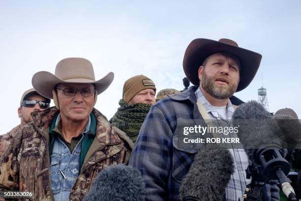 Ammon Bundy, leader of a group of armed anti-government protesters speaks to the media as other members look on at the Malheur National Wildlife...