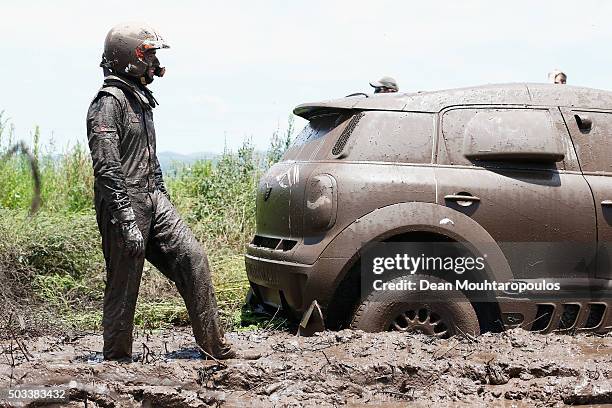 Nani Roma of Spain in the MINI ALL4 RACING for AXION X-RAID TEAM looks on after getting stuck in the mud as they compete between Villa Carlos Paz and...