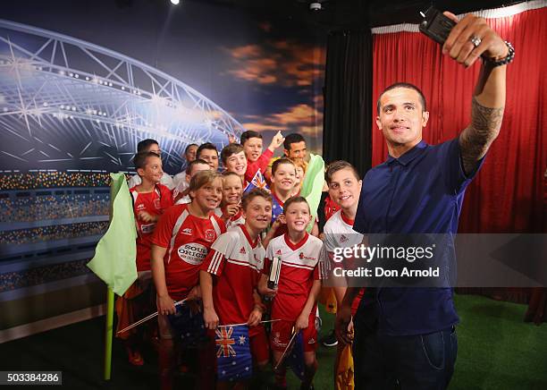 Tim Cahill takes a selfie alongside fans and his wax figure at Madame Tussauds Sydney on January 5, 2016 in Sydney, Australia.
