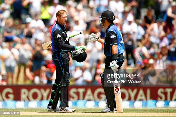 Martin Guptill of New Zealand celebrates his century with Ross Taylor during game five of the One Day International series between New Zealand and...