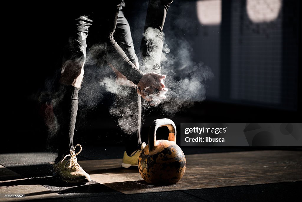 Gym fitness workout: Man ready to exercise with kettle bell
