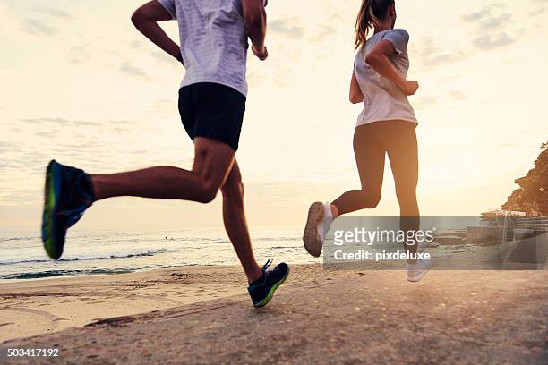 they keep each other moving - running stock pictures, royalty-free photos & images