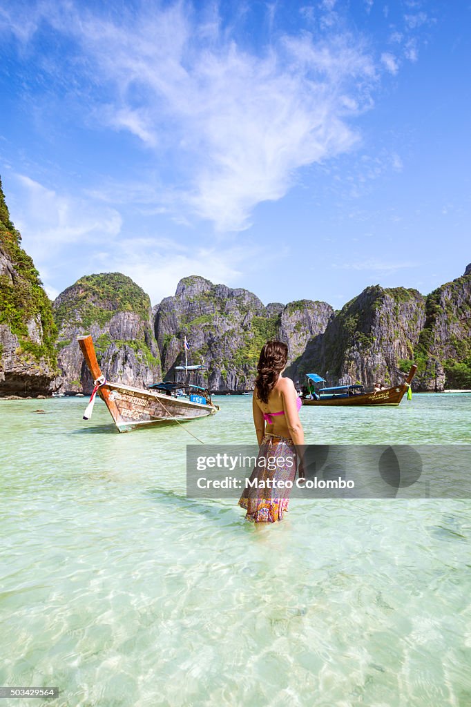 Female tourist standing in water on beautiful tropical beach, Thailand