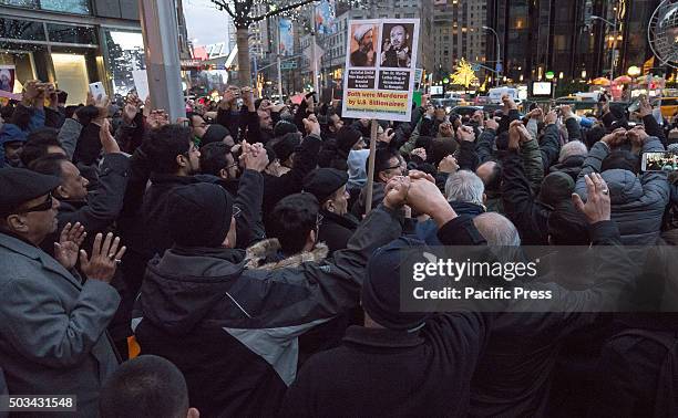 Demonstrators join hands while praying at the demonstration. Several hundred Muslim-Americans from the New York City metro area rallied in front of...