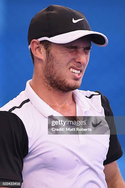 Oliver Anderson of Australia grimaces in his match against Ivan Dodig of Coratia during day three of the 2016 Brisbane International at Pat Rafter...