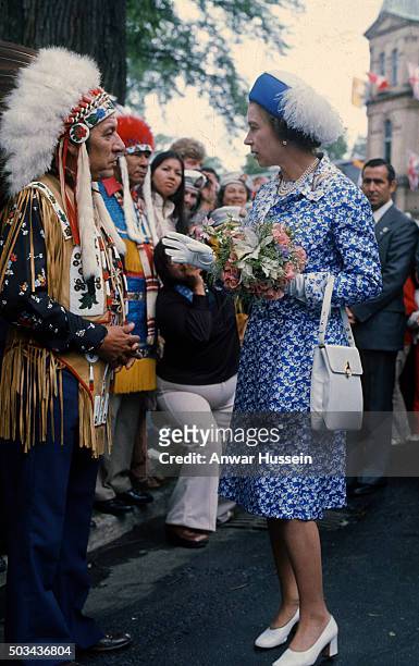 Queen Elizabeth ll chats to Native Americans during a tour of Canada on July 01, 1976 in Canada.