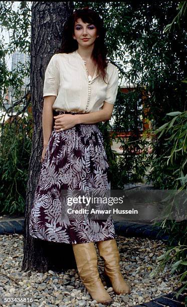 Successful female vocalist Kate Bush poses by a tree, in June 1978 in London, United Kingdom.