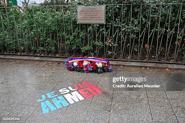 Flowers are left near the memorial stone in tribute to the police Officer Ahmed Merabet stone in next to former Charlie Hebdo office on January 5,...