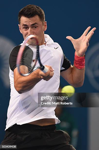 Bernard Tomic of Australia plays a forehand against Nicolas Mahut of France during day three of the 2016 Brisbane International at Pat Rafter Arena...