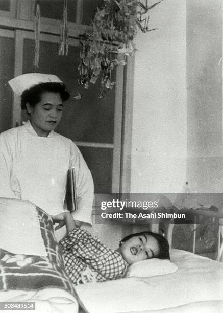 Minamata disease patient lies on the bed in the Minamata City Hospital on April 1, 1960 in Minamata, Kumamoto, Japan.