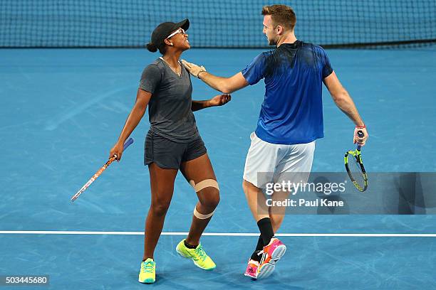 Victoria Duval and Jack Sock of the United States share a moment in the mixed doubles match against Jarmila Wolfe and Lleyton Hewitt of Australia...