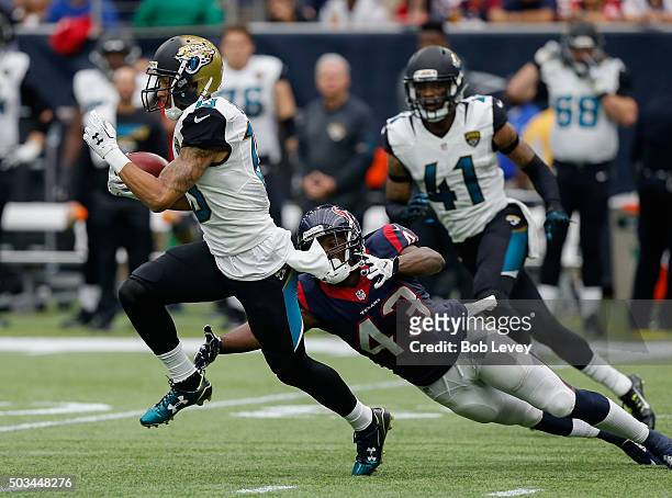 Rashad Greene of the Jacksonville Jaguars is tackled by Corey Moore of the Houston Texans at NRG Stadium on January 3, 2016 in Houston, Texas.