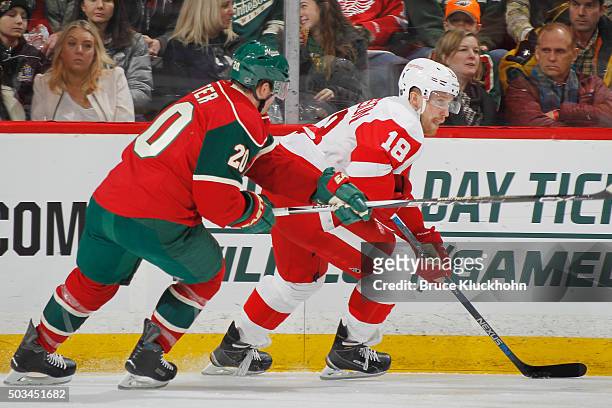 Joakim Andersson of the Detroit Red Wings skates with the puck while Ryan Suter of the Minnesota Wild defends during the game on December 28, 2015 at...