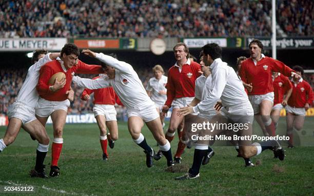 David Pickering of Wales breaks between Kevin Simms and Rory Underwood of England during their Five Nations rugby union match at the National Stadium...