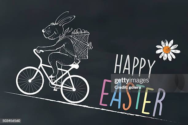 chalk drawing of cycling easter bunny on chalk board - easter wishes stock illustrations
