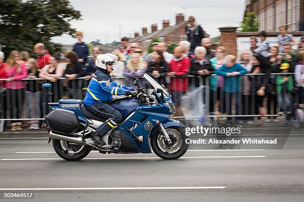 French Gendarmerie motorcyclist passes York Le Tour de France crowds