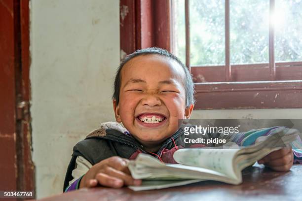 chinese boy with big smile at school,looking at camera - chinese people posing for camera stockfoto's en -beelden
