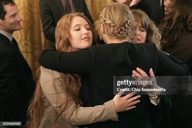 Comedian Amy Schumer embraces victims of gun violence after U.S. President Barack Obama delivered remarks about his efforts to increase federal gun...