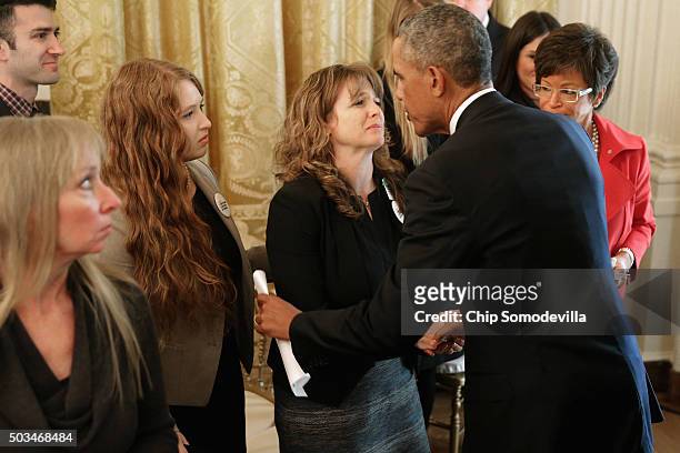 President Barack Obama greets victims of gun violence and their family members after delivering remarks about his efforts to increase federal gun...