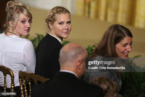 Comedian Amy Schumer and Health and Human Services Secretary Sylvia Mathews Burwell wait for the arrival of U.S. President Barack Obama before he...